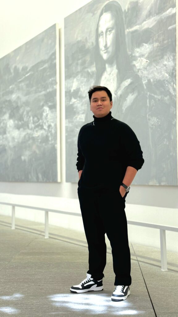 Mark Kevin Capili standing inside an art gallery